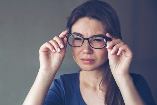 female with astigmatism squinting through classes and contemplating lasik surgery at Roholt Vision